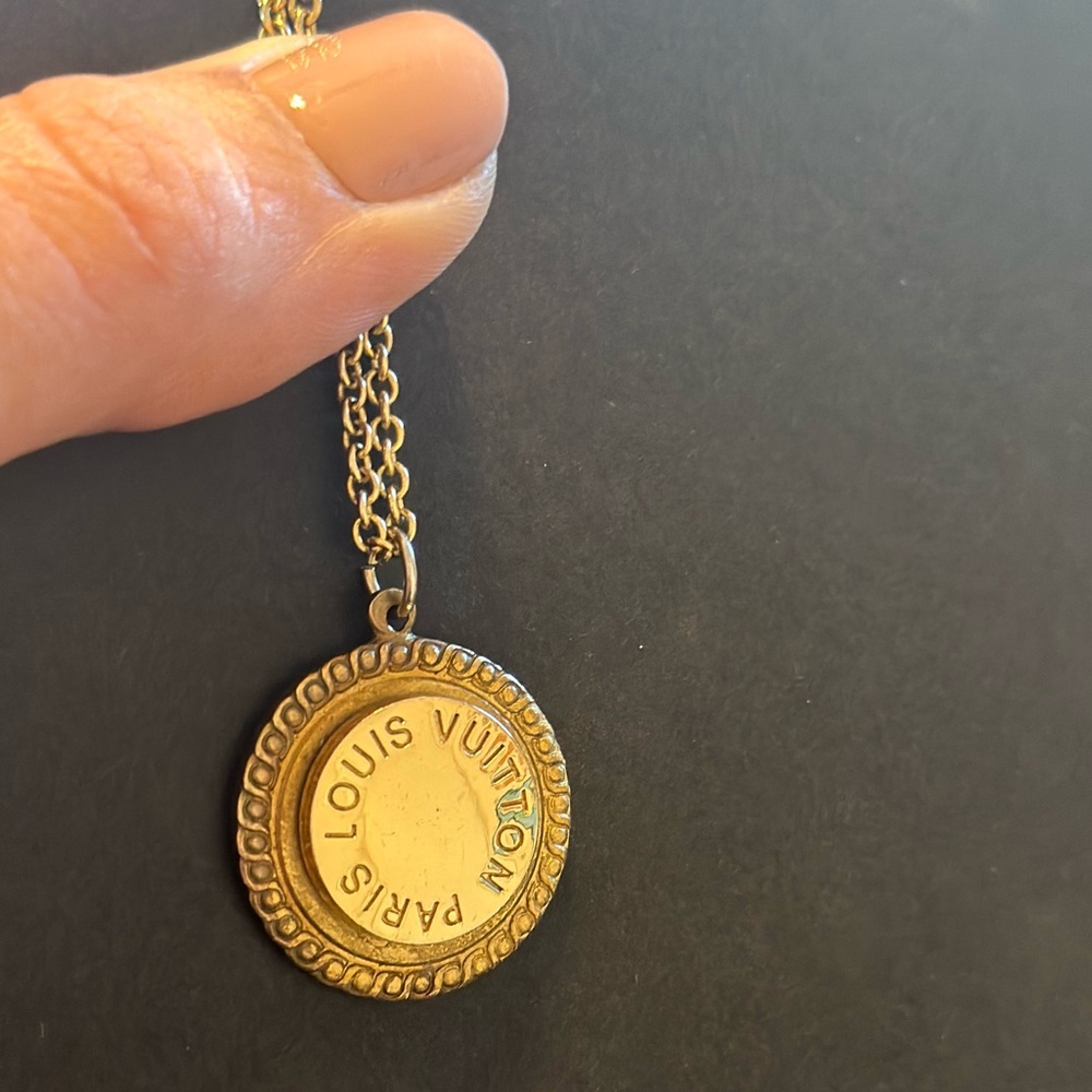 Custom necklace charm made from vintage Louis Vuitton purse button.